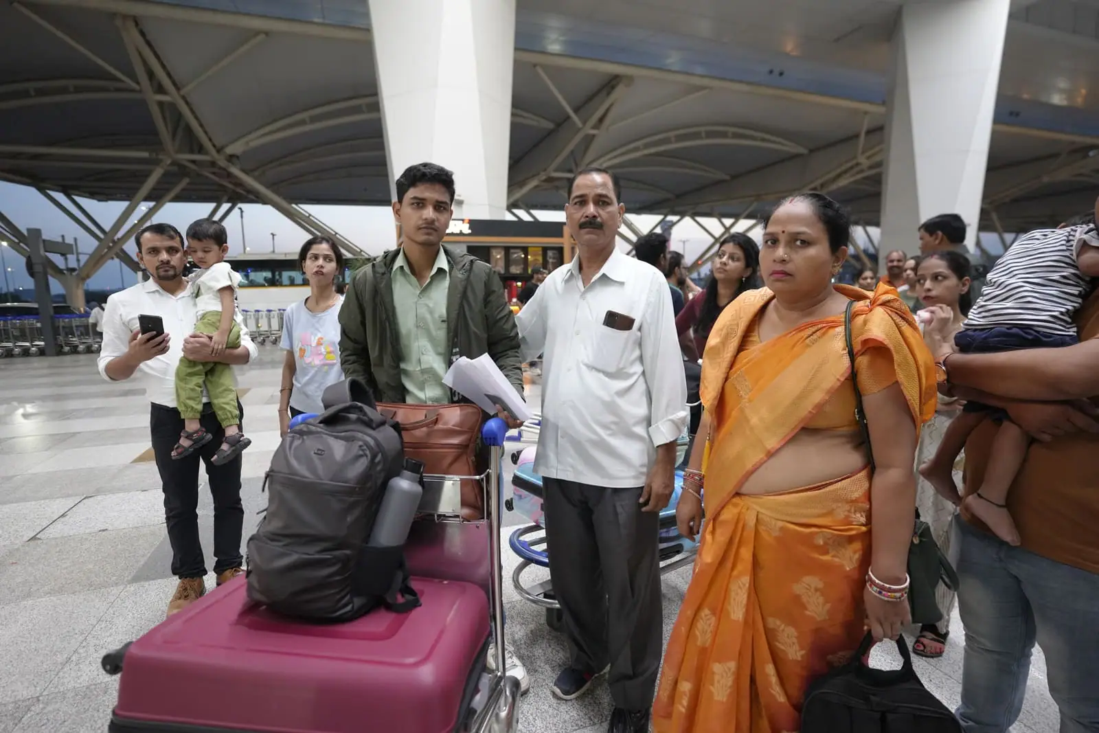 Students gathered with family at the airport ahead of their flight to university