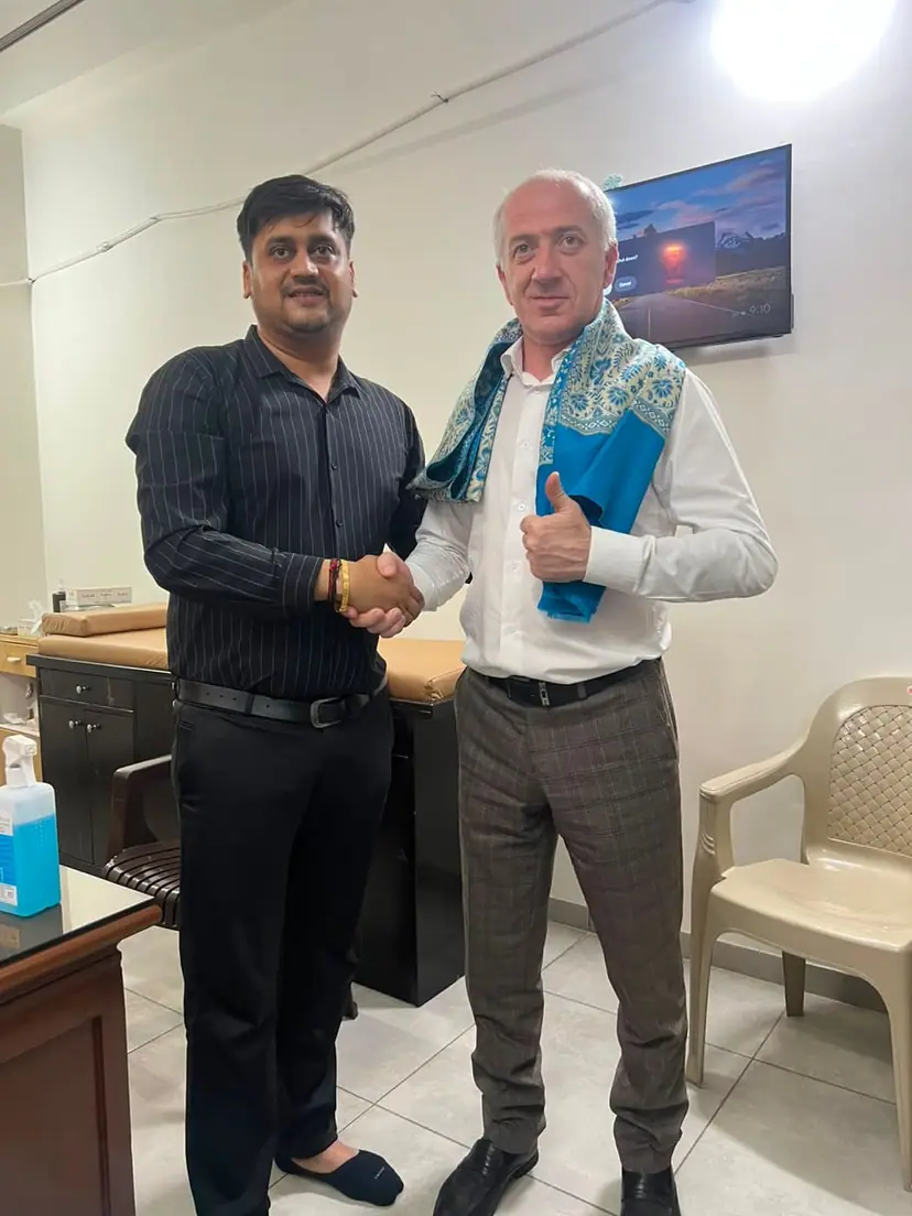 A Doctors Build International representative shaking hands with the Dean of North Caucasian State Academy