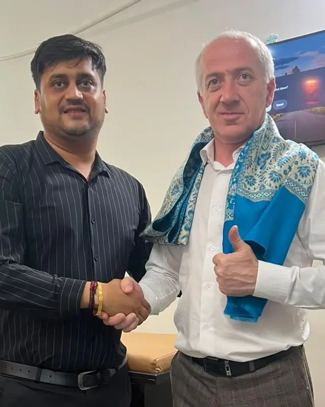A Doctors Build International representative shaking hands with the Dean of North Caucasian State Academy