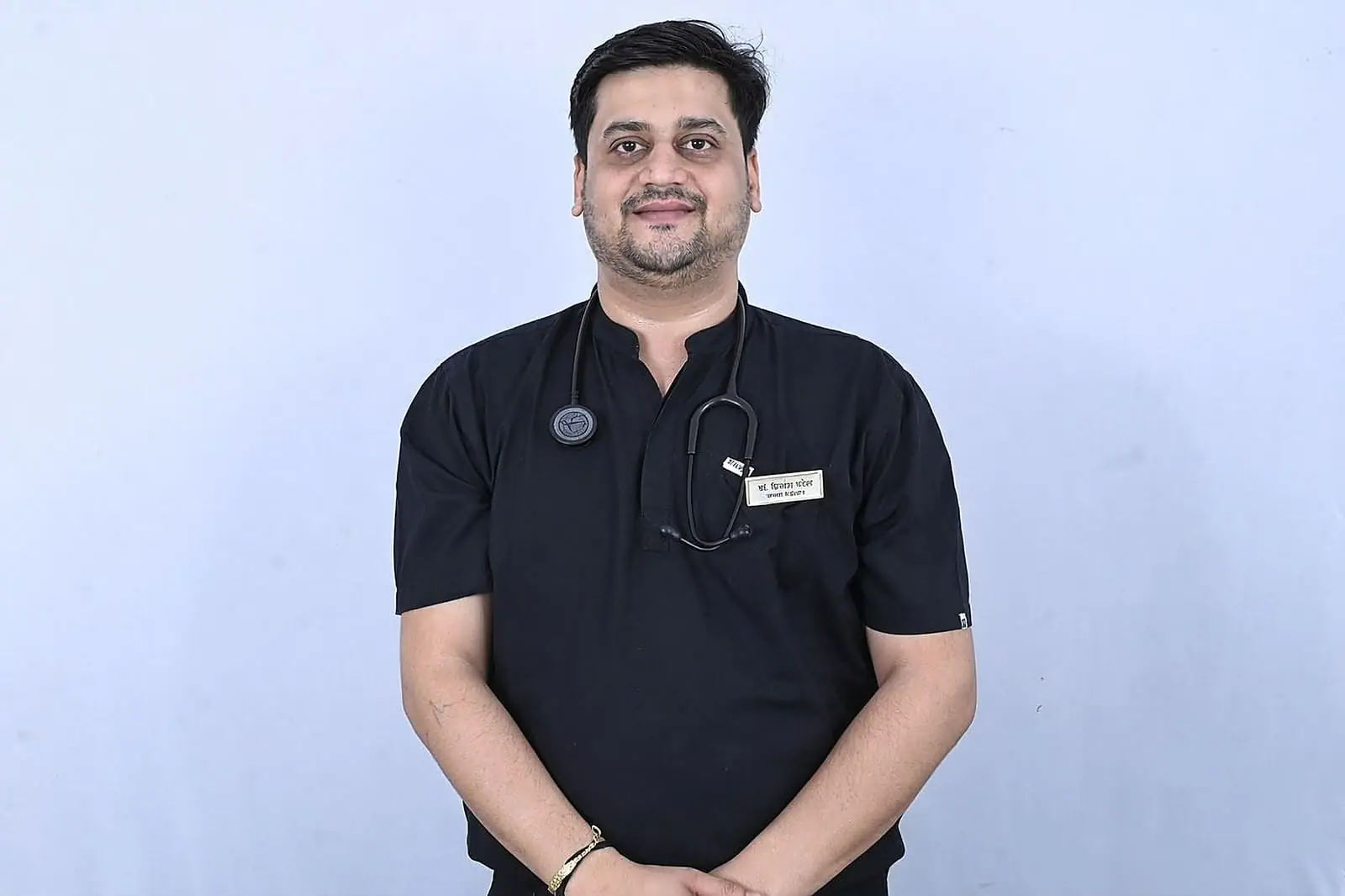 A member of the Doctors Build International team in medical scrubs