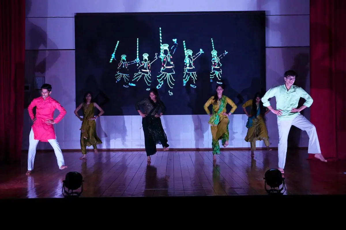 Students performing a group dance on stage at the freshers' evening at North Caucasian State Academy