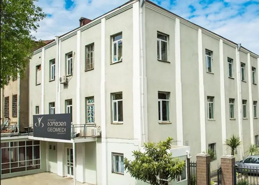 The GEOMEDI University building in Tbilisi, Georgia, with the university sign at the entrance